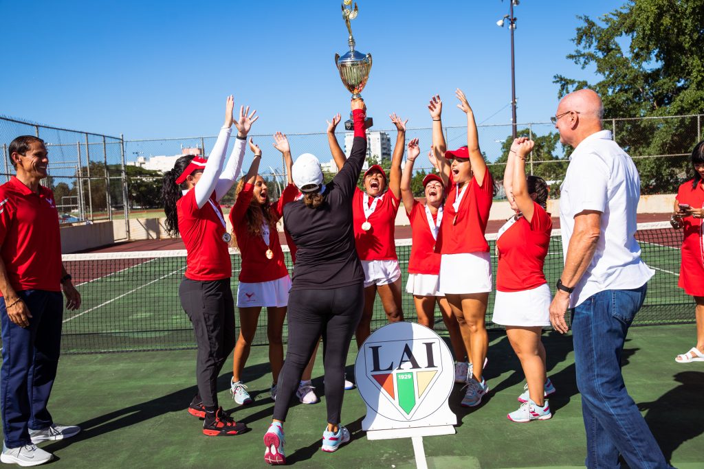Equipo de tenis de campo femenino del Recinto de Río Piedras posa con las medallas de oro y la copa del campeonato