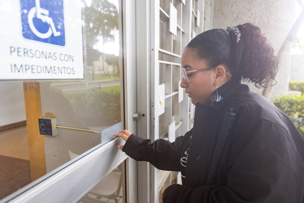 Luego de pegar las etiquetas, los estudiantes confirman su accesibilidad en las puertas principales de cada instalación.